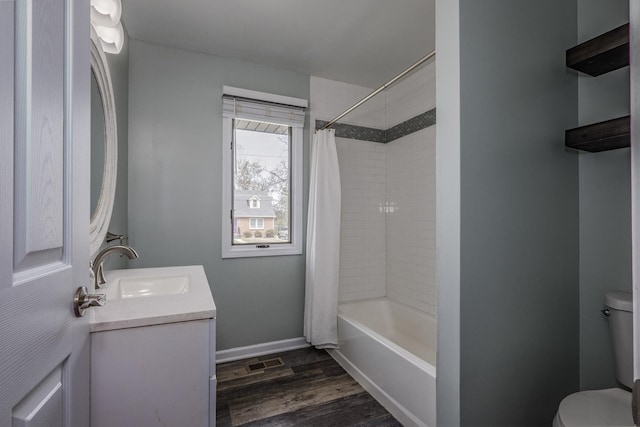 bathroom with vanity, visible vents, wood finished floors, toilet, and baseboards