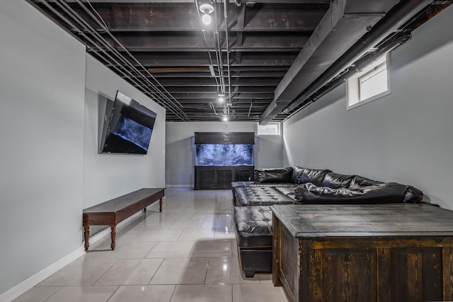 home theater room with baseboards and light tile patterned floors