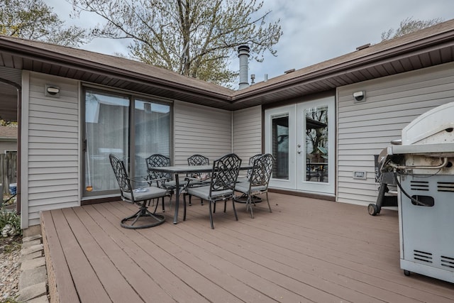 wooden deck featuring french doors and outdoor dining area