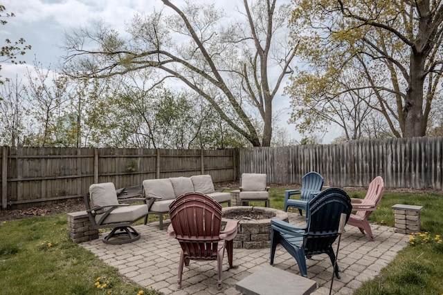 view of patio featuring a fenced backyard and an outdoor fire pit