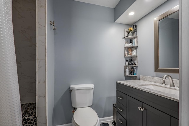 bathroom featuring vanity, toilet, recessed lighting, baseboards, and a shower stall