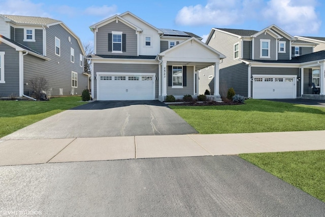 2523 Leander Ct, Woodridge, IL 60517 - view of front of house featuring an attached garage, solar panels, a front lawn, and aphalt driveway