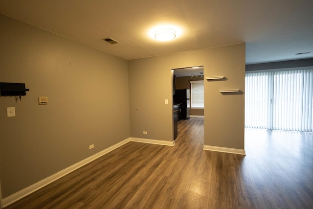 9132 Clairmont Ct Unit 113, Orland Park, IL 60462 - empty room with dark wood-style flooring, visible vents, and baseboards