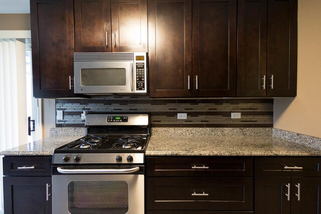 9132 Clairmont Ct Unit 113, Orland Park, IL 60462 - kitchen featuring stainless steel appliances, dark brown cabinets, and decorative backsplash