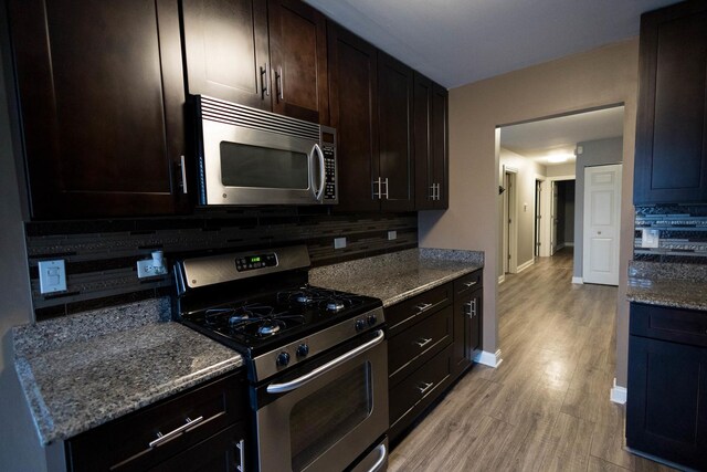9132 Clairmont Ct Unit 113, Orland Park, IL 60462 - kitchen with tasteful backsplash, appliances with stainless steel finishes, stone countertops, and light wood finished floors