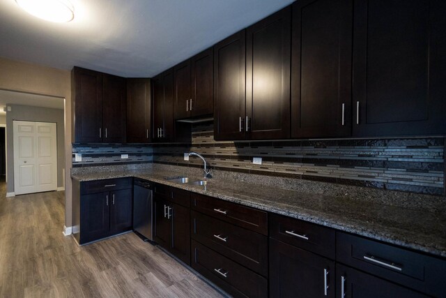 9132 Clairmont Ct Unit 113, Orland Park, IL 60462 - kitchen featuring stainless steel dishwasher, a sink, dark stone counters, and decorative backsplash