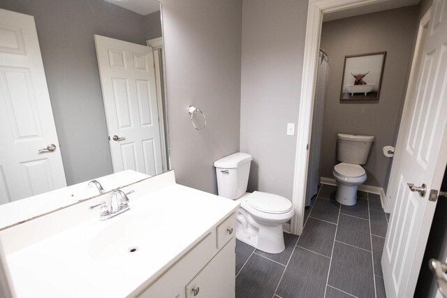 9132 Clairmont Ct Unit 113, Orland Park, IL 60462 - bathroom with tile patterned flooring, vanity, baseboards, and toilet