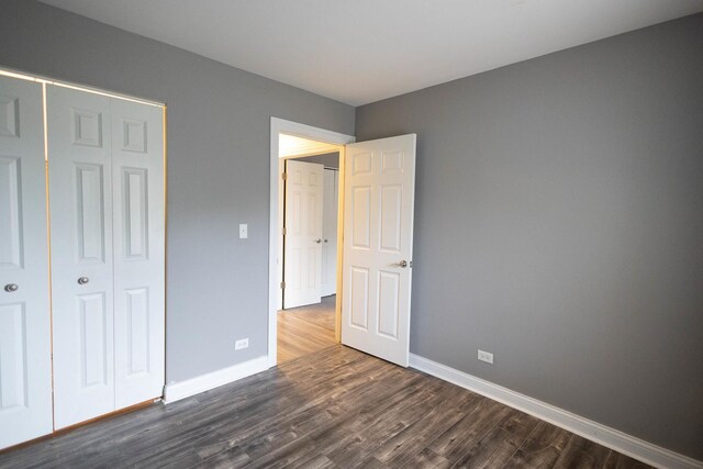 9132 Clairmont Ct Unit 113, Orland Park, IL 60462 - unfurnished bedroom with a closet, baseboards, and dark wood finished floors