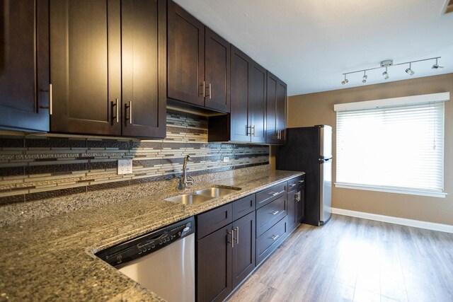 9132 Clairmont Ct Unit 113, Orland Park, IL 60462 - kitchen featuring dark brown cabinetry, dark stone countertops, backsplash, stainless steel appliances, and a sink