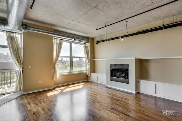 unfurnished living room with a fireplace and wood finished floors