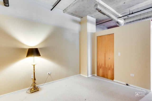 interior space with baseboards and carpet