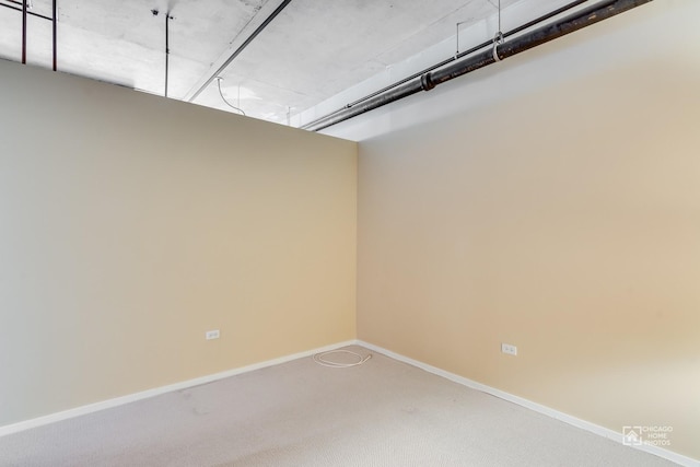 below grade area featuring baseboards and carpet