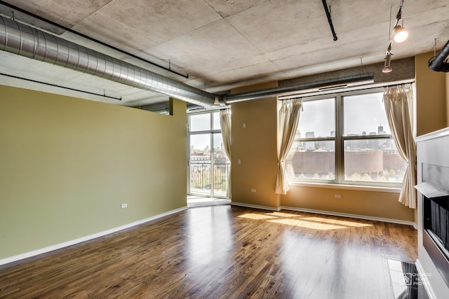 empty room featuring baseboards and wood finished floors