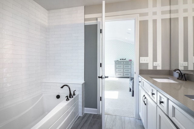 4118 Calder Ln, Aurora, IL 60504 - bathroom featuring a garden tub, vanity, wood finished floors, and vaulted ceiling