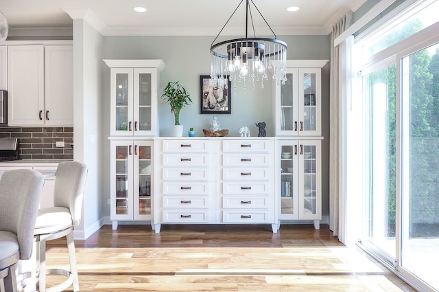 4118 Calder Ln, Aurora, IL 60504 - dining space featuring a chandelier, light wood-style flooring, ornamental molding, and recessed lighting