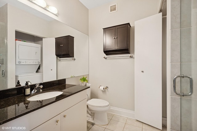 33 W Ontario St Unit 40D, Chicago, IL 60654 - bathroom featuring tile patterned floors, toilet, a shower stall, visible vents, and stacked washer / drying machine