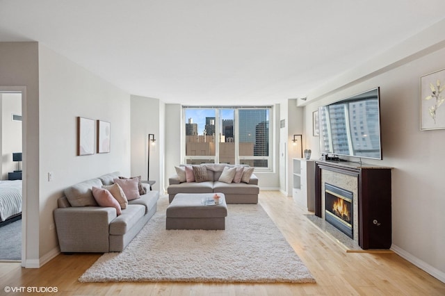 33 W Ontario St Unit 40D, Chicago, IL 60654 - living area featuring baseboards, a glass covered fireplace, and light wood-style floors