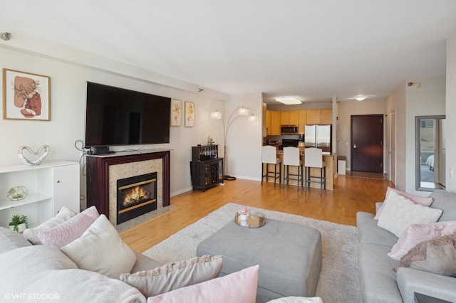 33 W Ontario St Unit 40D, Chicago, IL 60654 - living room featuring a fireplace with flush hearth and light wood-style floors