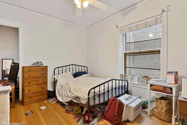 bedroom featuring a ceiling fan and wood finished floors