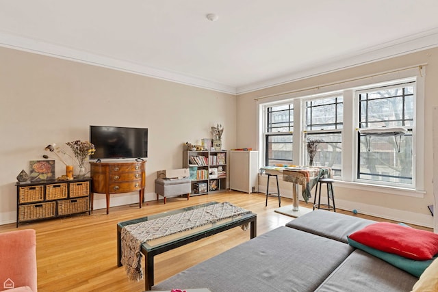 living room with ornamental molding and wood finished floors