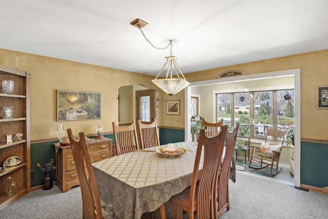 dining space featuring baseboards and carpet floors