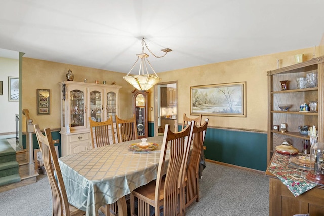 dining room with light colored carpet and baseboards
