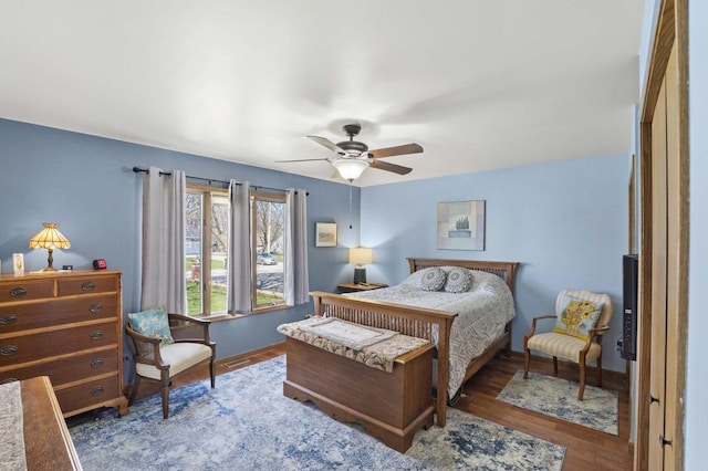 bedroom featuring wood finished floors, ceiling fan, baseboards, and visible vents
