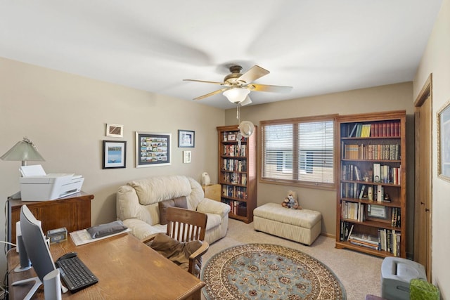 office area with carpet flooring, baseboards, and a ceiling fan