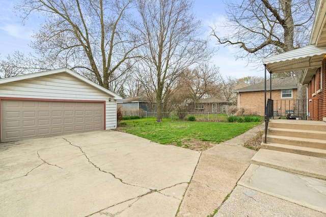 view of yard with an outbuilding, fence, and a garage
