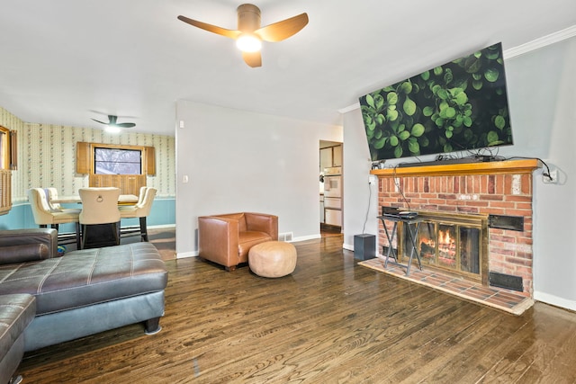 living room with baseboards, a ceiling fan, wood finished floors, and wallpapered walls