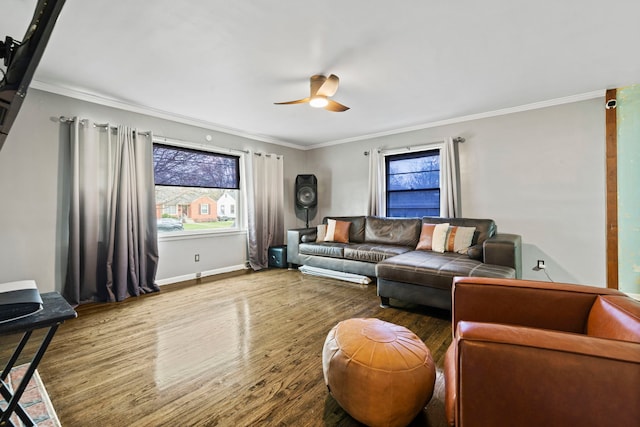 living room featuring ornamental molding, ceiling fan, wood finished floors, and baseboards