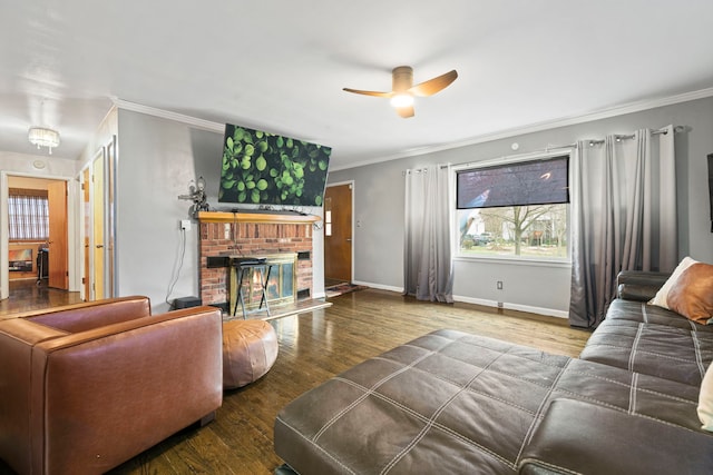 living room with ornamental molding, baseboards, a ceiling fan, and wood finished floors