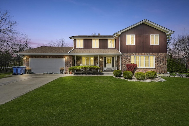 traditional home with a garage, a front yard, brick siding, a porch, and driveway