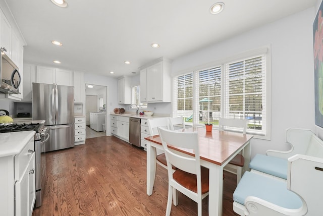 dining room featuring washer / dryer, recessed lighting, and wood finished floors