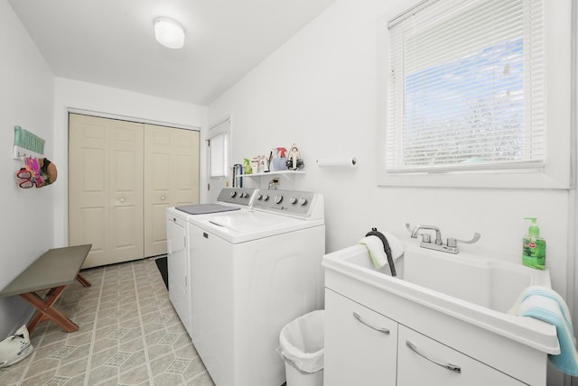 clothes washing area featuring washing machine and clothes dryer and cabinet space