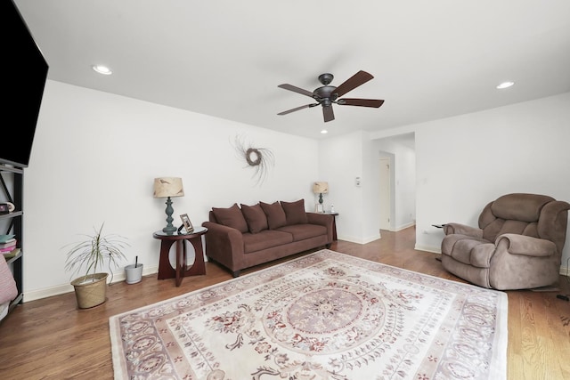 living room featuring baseboards, a ceiling fan, recessed lighting, and wood finished floors