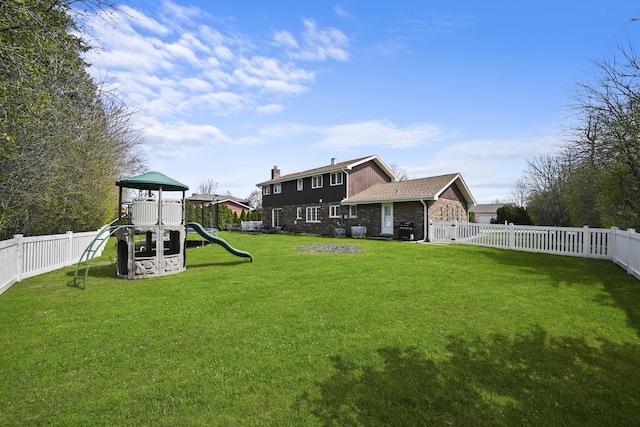 view of yard with a fenced backyard and a playground