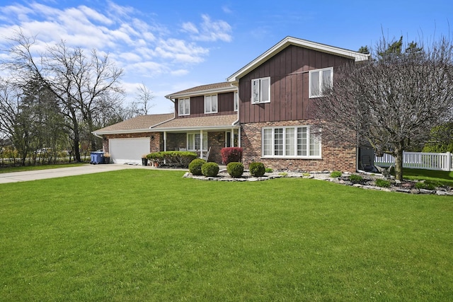 traditional home with brick siding, driveway, a front lawn, and a garage