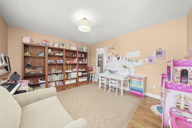 rec room featuring baseboards and wood finished floors
