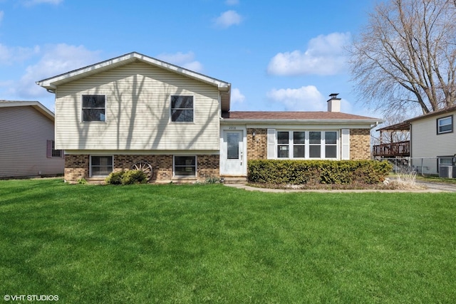 2018 Fairfield Rd, Lindenhurst, IL 60046 - split level home with brick siding, a chimney, and a front yard