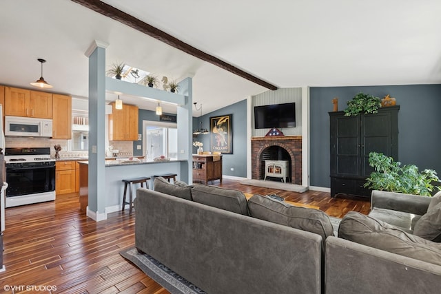 2018 Fairfield Rd, Lindenhurst, IL 60046 - living area featuring baseboards, lofted ceiling with beams, a wood stove, and dark wood-type flooring
