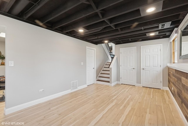 2018 Fairfield Rd, Lindenhurst, IL 60046 - finished below grade area featuring baseboards, visible vents, stairway, and light wood-type flooring
