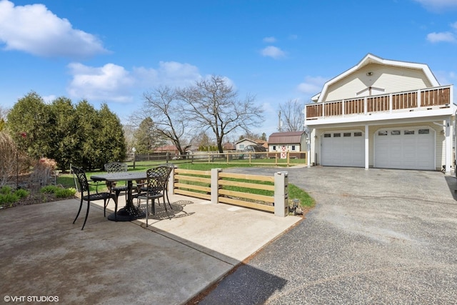 2018 Fairfield Rd, Lindenhurst, IL 60046 - view of patio / terrace featuring fence, outdoor dining space, an attached garage, and driveway
