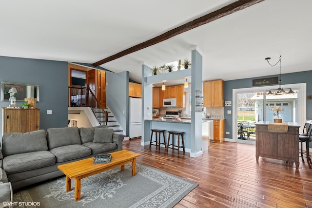 2018 Fairfield Rd, Lindenhurst, IL 60046 - living area featuring a chandelier, lofted ceiling with beams, wood finished floors, and stairway