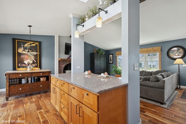 2018 Fairfield Rd, Lindenhurst, IL 60046 - kitchen featuring hanging light fixtures, light stone countertops, vaulted ceiling, and wood finished floors