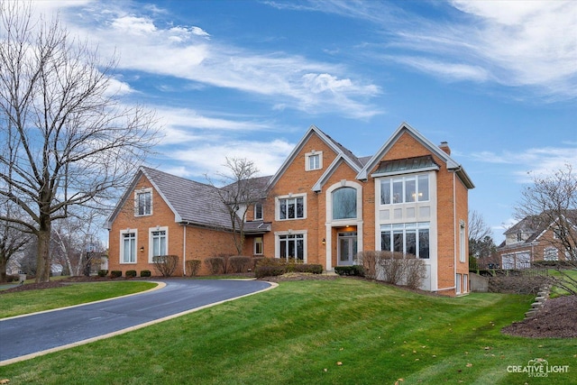 70 New Abbey Dr, Inverness, IL 60010 - view of front of property with a chimney, a front yard, and brick siding