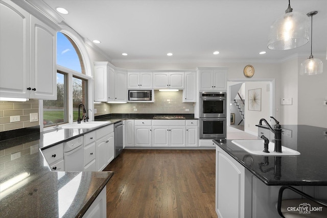 70 New Abbey Dr, Inverness, IL 60010 - kitchen featuring ornamental molding, white cabinets, dark wood-type flooring, stainless steel appliances, and a sink
