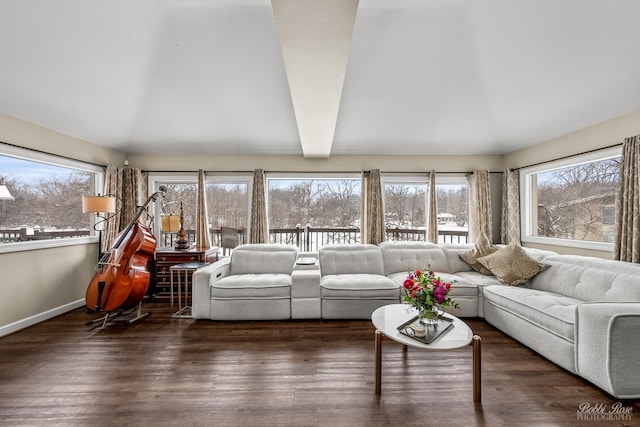 sunroom / solarium featuring beamed ceiling and plenty of natural light