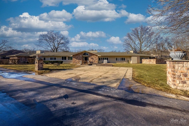 single story home featuring a front yard and a chimney