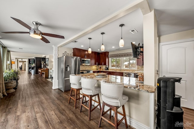 208 Brookdale Ln, Palatine, IL 60067 - kitchen featuring appliances with stainless steel finishes, decorative backsplash, a peninsula, a kitchen breakfast bar, and ceiling fan